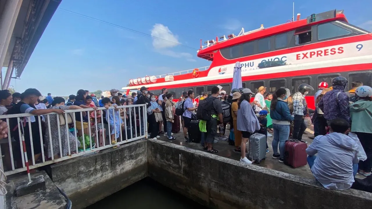 Passengers queue and check in on the ship Phú Quốc Express at the port Hà Tiên